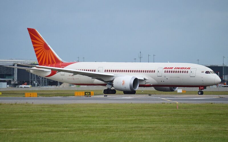 An Air India Boeing 787 aircraft taxiing on the runway during the day, representing the airline's international fleet.
