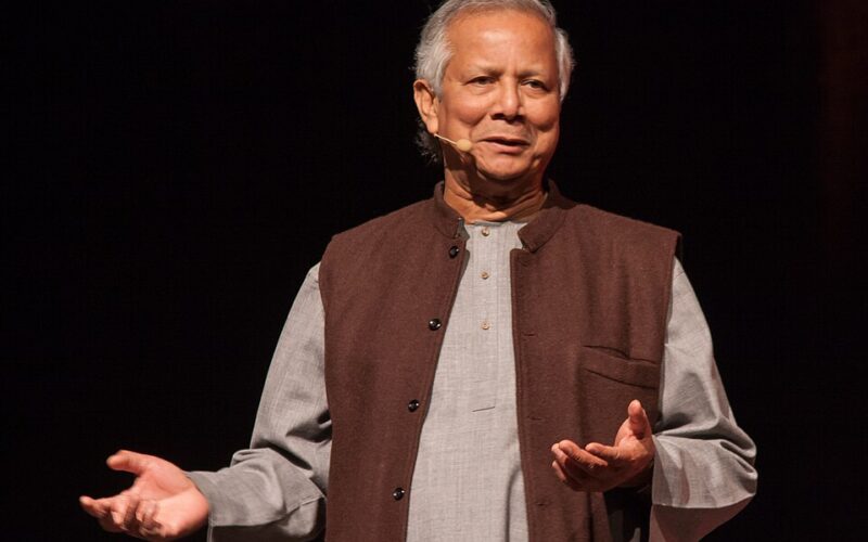 Portrait of Nobel Peace Prize laureate Professor Muhammad Yunus smiling at an official event.